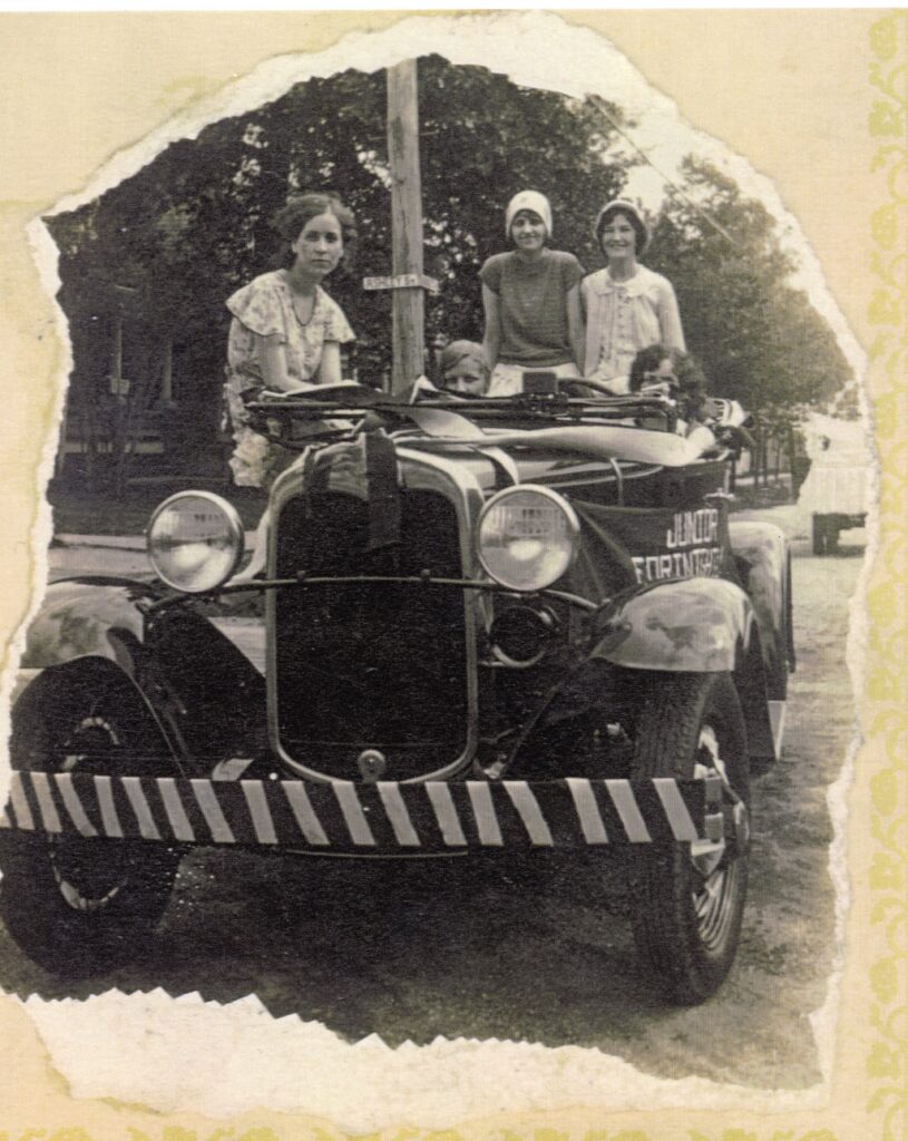 Junior Fortnightly club womensit in an automobile, black and white. Estimated 1930s.